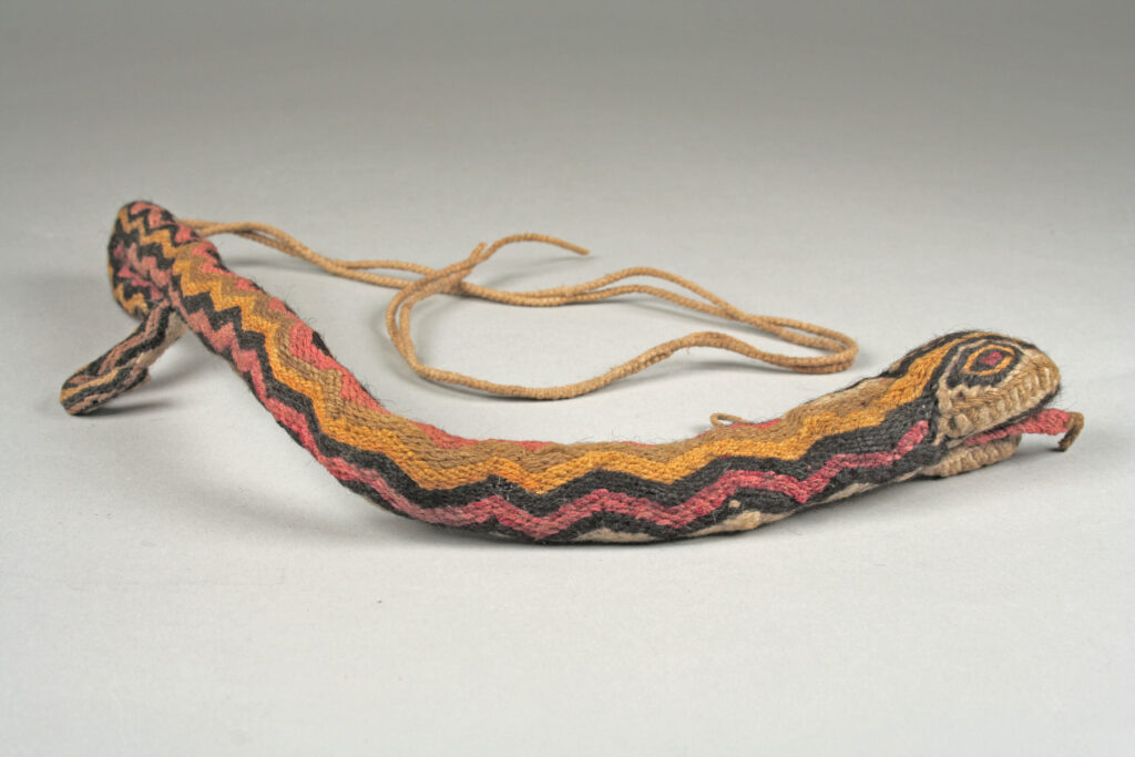 Three-dimensional textile serpent with zigzag-patterned body, open red mouth, and concentric elliptical eyes, associated with Inca serpent veneration, Peru, 15th–16th century CE.