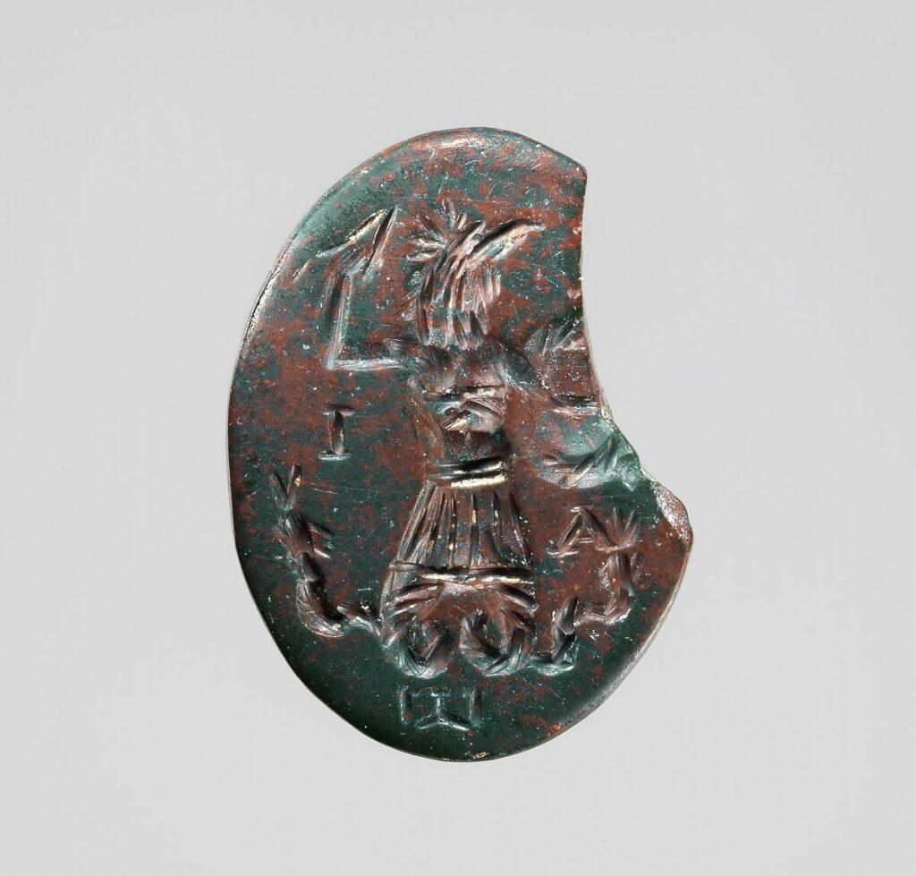 Engraved gemstone showing a figure with a rooster's head, armored torso, and two serpents in place of legs.