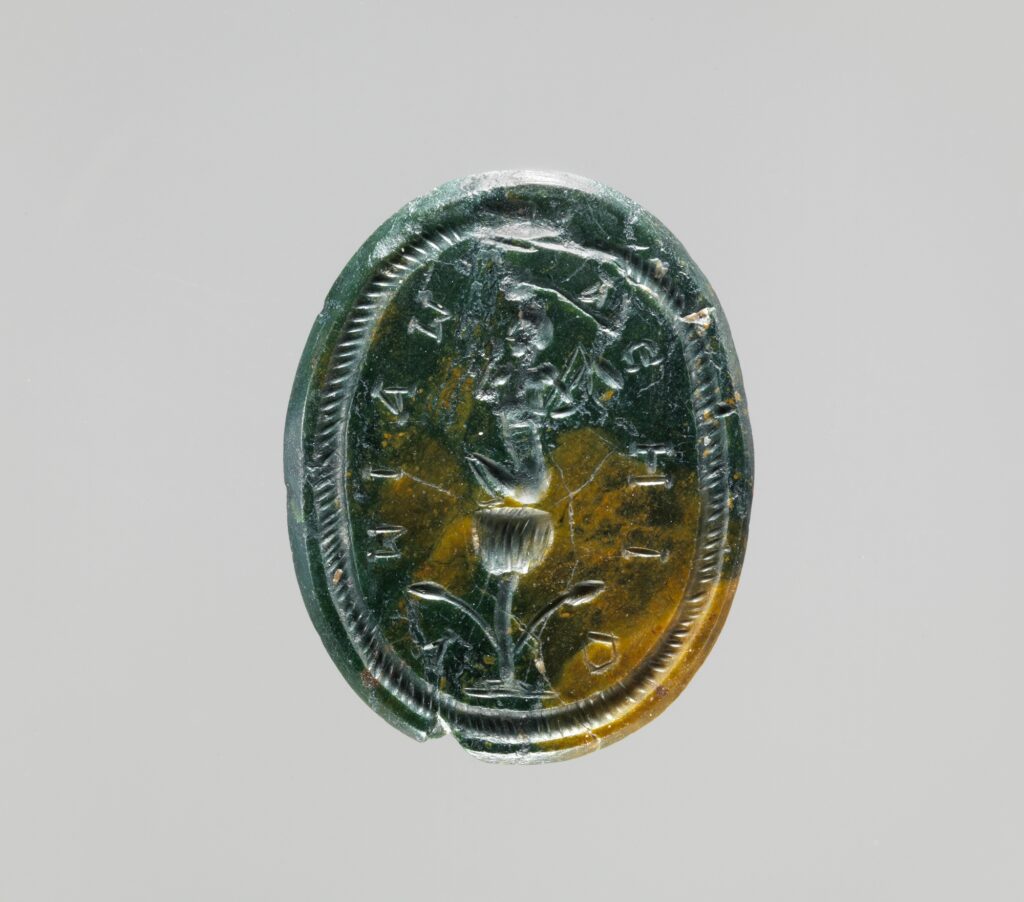 Engraved gemstone showing a seated god on a lotus flower, encircled by a serpent biting its own tail.